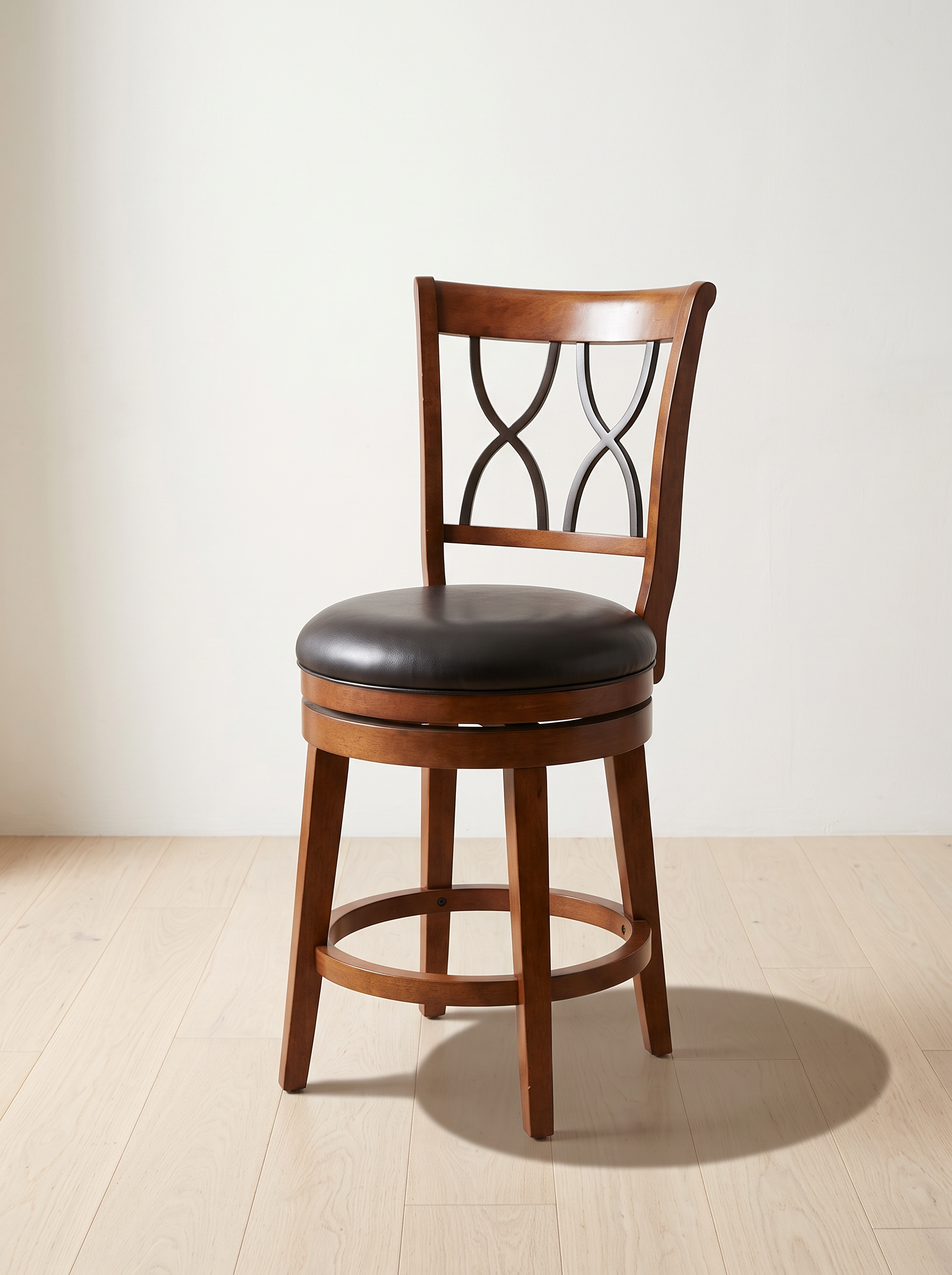 The Black Leather-Look Swivel Bar Stool on the J&S showroom floor in Atlanta